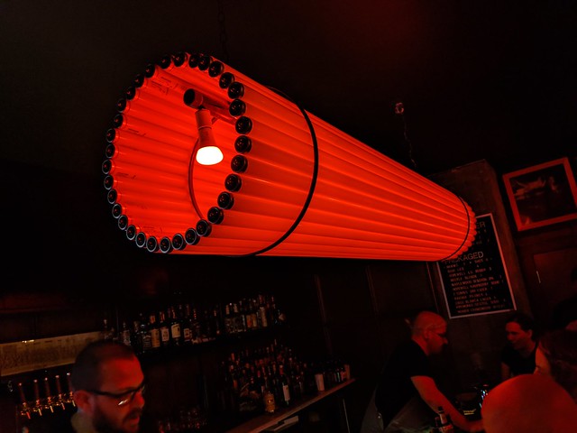A crazy light made of fluorescent tubes with hue bulbs inside.