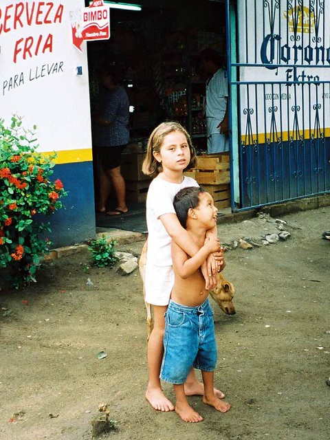 Some children and a dog in a small village