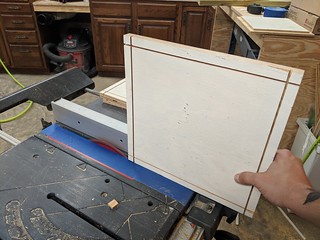 Finishing up the dados (with my "zero clearance" tape insert to prevent scraps from falling down ...