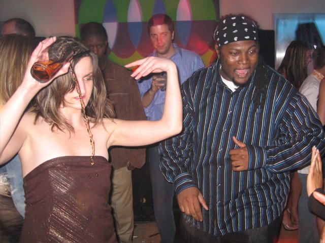 Lenny Twin and some girl dancing while pouring a drink out all over herself.