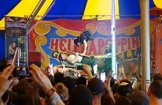 The half man jumping on a guy laying on a bed of nails