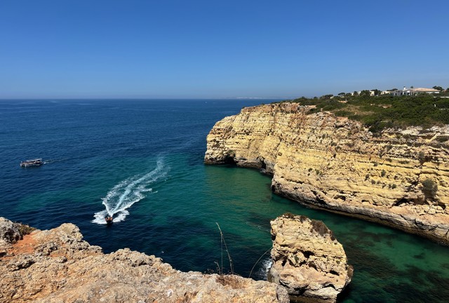 A boat cruises into the cove