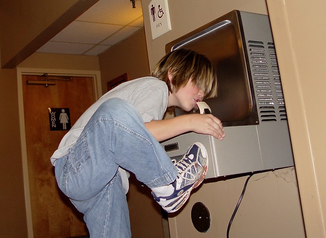 Ethan Terronez drinking out of a drinking fountain ... with his foot