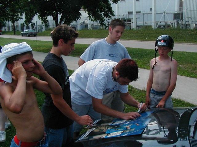 Zach signing posters for the kids