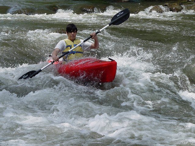 Gabe kayaking over the dam