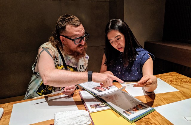 Hiromi helping us order a bunch of fish, beef, and pickled things