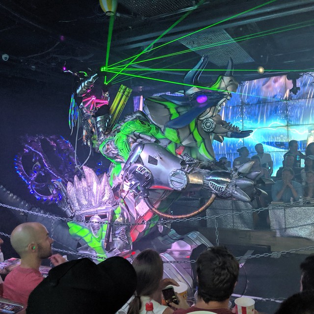 Crazy robot riding a robot triceratops dude