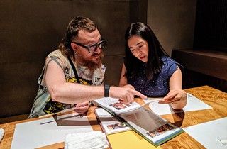 Hiromi helping us order a bunch of fish, beef, and pickled things