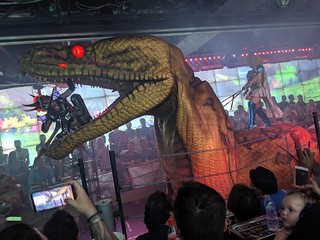 This woman just jumped into that robot dinosaur's mouth and is trying to stab it
