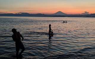 Sunset - Playing in the ocean as the sun sets behind Fuji