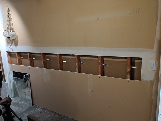 For the new floating bartop, I didn't wanna cut/patch the good drywall in the rec room, so I went int from the back-side - our storage room