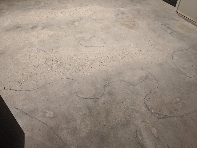 Marking out some mildly low spots after the concrete guy came out twice