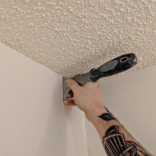 Tools - Scraping the edges off the popcorn to cut a clean line of paint against the ceiling