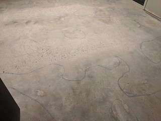 Marking out some mildly low spots after the concrete guy came out twice