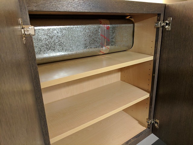 Managed to save a bit of shelf space by using oval ducting and pushing it up into the back corner of the cabinet