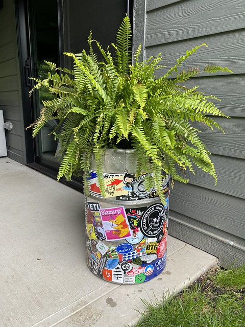 Sticker bombed keg planter dude
