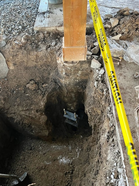 Helical pier attached to the footing