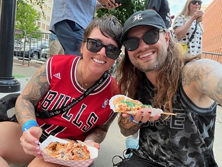 Models of good health. Eating some terrible incredibly fried food with sauce all over