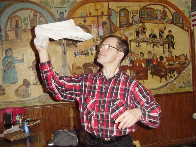 Trying to teach Charlie how to spin a towel at Pizza Palace