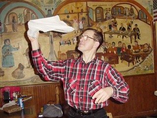 Trying to teach Charlie how to spin a towel at Pizza Palace