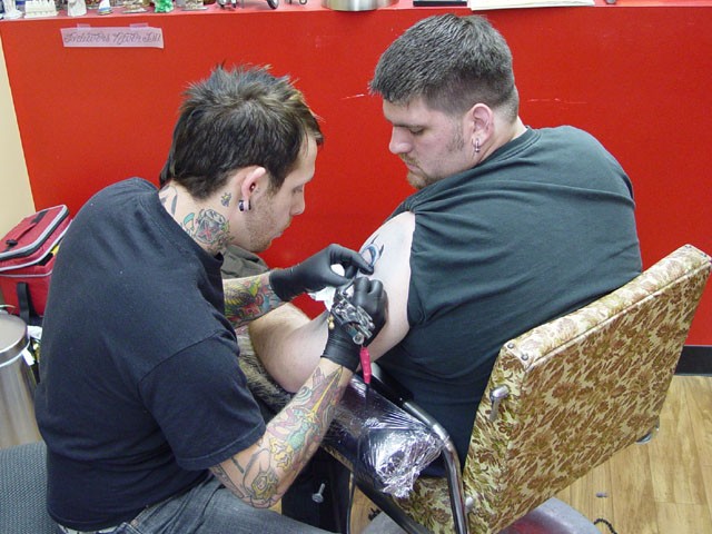 Kevi getting tattooed by Ace Wilde