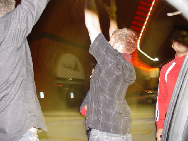 Aaron celebrating to a girl's boyfriend after getting a kiss on the cheek from her