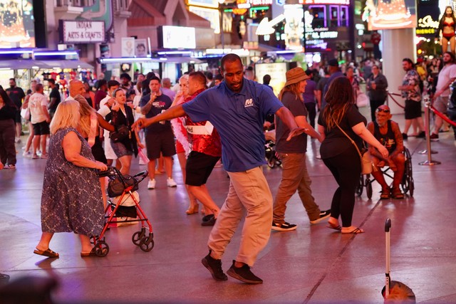 This man had just gotten off of work or something and just started busting a move to the music outside.