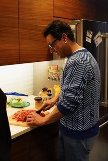 Cutting up hot dogs and tomatoes