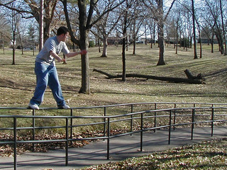 Zach sliding a handrail at a park at WIU