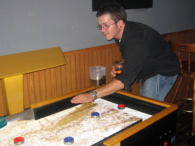 Zach playing shuffleboard (In remembrance of Josie B's)