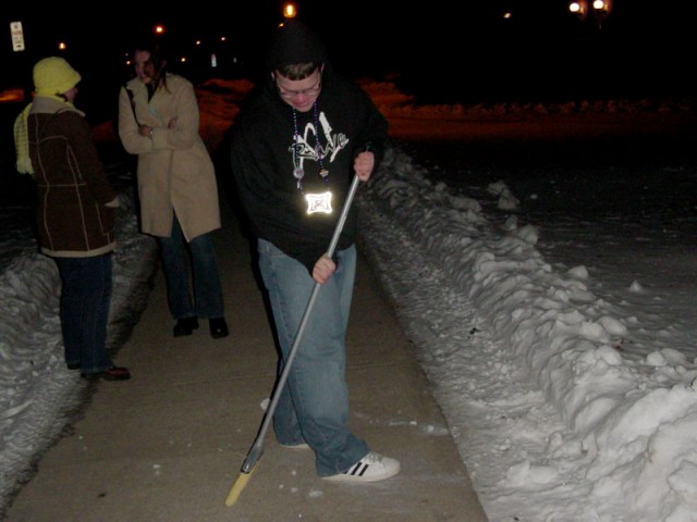 Zach sweeping the sidewalks