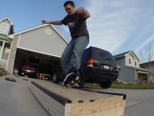 Zach nailing a wheelbarrow on my box.  (hehehehehe)